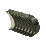 End-on view of shell stack with locating tabs and oil feed holes visible on grooved upper halves, plain lower halves behind