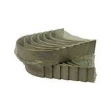 Angled view of the plastic-wrapped bearing shells showing the curved inner bearing surface and stamped outer backs with NDC logo
