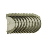 Top-down view of stacked bearing shells in clear shrink wrap showing half-shell profile and oil groove