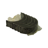 Angled view of the shell stack with oil feed holes visible through the packaging and faint edge stampings on the shell backs