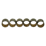Six bushings lying horizontally in a row, profile view clearly showing the split seam line and bi-metal steel-on-bronze wrapped construction