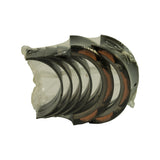 Shrink-wrapped stack of crescent bearing shells shown end-on, bi-metal steel backing with copper-coloured interlayer visible on several halves
