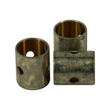 Two bushes upright showing the bronze inner bearing surface, one tipped on its side with the PB-2401-STD NDC stamping and oil hole visible