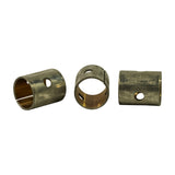 Three bushes in a row demonstrating the split cylindrical construction, bronze bore, and offset oil feed hole