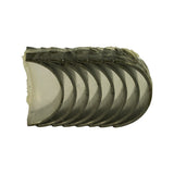 Front view of the eight nested bearing half-shells stacked inside their vacuum-formed plastic wrap, showing the polished aluminium running surfaces