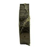 Side profile of the wrapped stack showing uniform bearing thickness and faint moulded stamp characters visible through the plastic on one shell