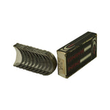 Overview showing full set of bearing shells removed from box and fanned out beside the original black King 'Engine Bearings' branded box. Shells display silver-coloured bimetal bearing surface on inside face; outer steel back visible at top edge.