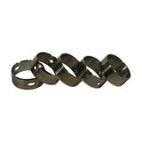 Five camshaft bearings laid in a row on their sides, showing oil feed holes and slots at different positions on each bearing, indicating each is sized and indexed for a specific journal position.