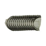 Side view clearly showing fourteen crescent-shaped bearing half-shells stacked together, with oil feed holes visible on each shell's bearing surface