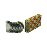 Overview: sealed bearing stack in factory shrink-wrap laid beside the orange, black and white Daido Metal checkered box showing 'MADE IN JAPAN' and end label M5874A 0.25 ER27