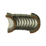 Top-down view of stacked bearing shells in clear shrink-wrap showing five pairs of half-shells with copper tri-metal parting faces exposed