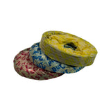 Overhead three-quarter view of the three wrapped ring bundles stacked loosely, oil pack noticeably taller than the two compression packs