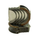 Main bearing set in original clear shrink-wrap, 001 size marking visible on back of one shell, tri-metal construction with exposed copper-lead intermediate layer on flanged thrust bearing