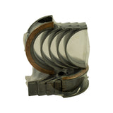 Front view of bearing set showing oil feed holes in the plain shells and the wider flanged thrust bearing at left, EB marking partially visible on reverse of shell