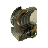 Angled view of the five bearing pairs in shrink-wrap, clearly showing oil feed holes in each upper half and the copper-coloured thrust flange
