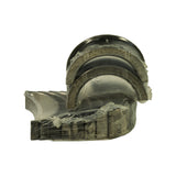Set of plain-bearing shells in clear wax paper wrap, showing multiple half-shells including a flanged thrust bearing pair on top
