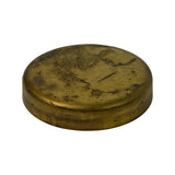 Side profile view showing the shallow cup form of the plug — flat rim, gently domed top surface, and the characteristic thin-wall brass construction of a cup-style welch plug.