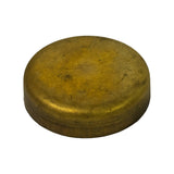 Three-quarter angle view showing the full cup profile — domed convex top, cylindrical side wall, and the sealing rim at the base; brass construction and cup-type design clearly visible; condition consistent with uninstalled NOS part.