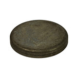 Three-quarter angled view of convex face showing shallow dome profile and rim depth; large diameter relative to previous plugs in series; uniform dull grey-green surface throughout