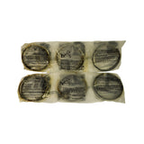 Six individual per-cylinder ring sets displayed in two rows of three, each in a poly bag with Cofap installation instructions and a ring-gap table printed on the packaging. Large round metallic piston rings visible through translucent bags. Some surface discolouration from age but rings appear structurally intact.