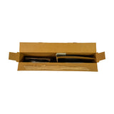Top-down view into open box showing internal cardboard tray with two compartments. Left compartment contains cast iron compression rings; right compartment contains darker coil-spring oil ring expander and steel rails.