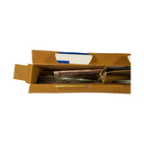 Angled top-down open-box view showing gold-toned corrugated expander/oil rails on the left and dark compression rings with instruction slip at centre-right. All rings appear undisturbed and undamaged.