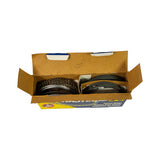 Open box viewed from above showing two groups of rings in cardboard sub-dividers: left group contains expander and oil rail segments (wavy/mesh profile), right group contains flat compression rings. All rings appear unused with no surface corrosion.