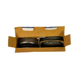 Open box from directly above, clearer view of both ring stacks. Left stack shows oil control expander rings, right stack shows compression rings. Box interior shows minor wear; rings appear complete and undisturbed.