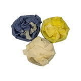 Reverse side of the three ring packs, wrappings partially unfolded revealing metallic ring surfaces inside blue, yellow and white tissue paper.
