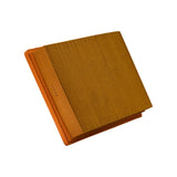 Three-quarter view of filter corner showing pleat depth, orange PU moulded frame, and a small embossed code stamped into the side face