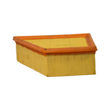Three-quarter top-rear view revealing the orange-framed intake face with yellow pleated media panel across the full top surface. Trapezoidal/parallelogram planform visible.