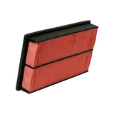 Three-quarter angled view showing full depth of the filter, the raised lip along one long edge, and a triangular red felt/foam sealing tab at each corner of one short end