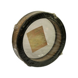 Rear three-quarter view, label seen in reverse through shrinkwrap. Brown/gold outer mesh screen visible around full circumference. Second barcode sticker partially visible on lower edge.