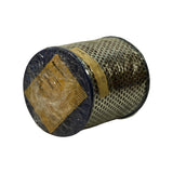 End face of filter (bottom), laid on its side. Gold paper Ryco-style label visible on end cap, partially legible through crumpled plastic wrap. Text reads 'MADE IN NEW ZEALAND', 'TYPE:', 'PART NUMBER:' — fill-in values not legible. Perforated casing and blue rubber seal ring visible around perimeter.