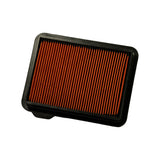 Top face of filter element from a slightly lower angle. Full extent of orange pleated media and full perimeter of black plastic frame visible. Small stepped tab visible at lower-left corner. No markings visible on top face.