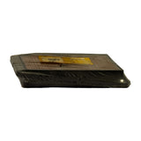 Edge-on side profile of sealed filter, low angle, showing shallow depth of filter body and wrap integrity. Label partially visible on top face.