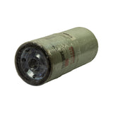 Filter laid on side showing threaded base end clearly — black rubber seal ring and multiple small secondary bolt-hole ports around the central thread visible through the wrap. Fleetguard label partially readable.