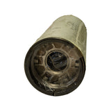 Base plate of filter, angled view. Stamped steel base with centre threaded inlet port surrounded by radial inlet holes and outer rubber gasket ring. Polywrap hanging loose at base. Heavy surface patina on metal base plate consistent with age.