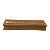 Low-angle side view showing outlet mesh face and pleated media edge, filter laid flat showing overall proportions.