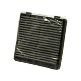 Diagonal top-down view of filter face, showing full extent of pleated carbon media and corner mounting tabs; no visible text or markings on media face
