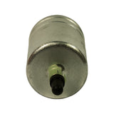 End-on view of inlet port — black rubber protective cap installed in centre, green quick-connect retainer clip visible around port, unpainted steel canister end face with light surface tarnish.