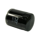 Filter laid on its side at an angle, OE+ branding and PMO1528 readable. Faint date/batch code visible on far side of canister near base.