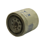 Low-angle view showing the filter base plate from slightly above, with inlet holes and threaded centre clearly visible alongside the label area.