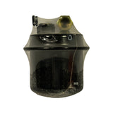 Top-down view of filter showing two threaded port fittings: a brass hexagonal banjo-bolt port and a smaller square-head service/bleed bolt. Filter partially unwrapped from factory clear polybag.