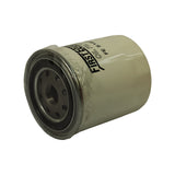 Filter angled to show base plate face-on alongside body. Nine-hole inlet pattern clearly visible. Central threaded boss for engine block mounting. Minor surface marks consistent with shelf storage. No deformation or damage.