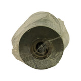 Bottom of filter element through plastic wrap. Stamped metal base plate with central threaded inlet port and circumferential flat sealing surface. Partial stamped text visible reading 'MADE IN MEXICO' around rim.