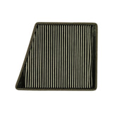 Filter presented at a different angle showing top face and both the taller and shallower sides of the tapered plastic frame. Pleated media surface uniformly charcoal-grey with no visible soiling.