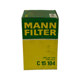 Front face of the green-and-yellow Mann-Filter retail box. Part number C 15 104 printed large on the lower yellow panel alongside multilingual 'Filtro per l'aria / Filtro de ar' text. Barcode sticker visible on top-right of box lid. Box shows shelf scuffing and light creasing.