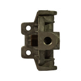 Top-down view of the metal filter base casting removed from packaging. Central threaded stud visible with surrounding casting body and NPT port fittings.