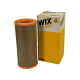 Filter element alongside original WIX Filters retail box. Box is white/yellow with WIX Filters branding, part number WA6486 printed on front and top flap, barcode visible on top. Box shows wear consistent with shelf storage — minor scuffing and compression to corners.